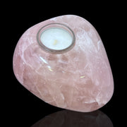Rose Quartz Freeform Tea Light Candle Holder on black, polished pink stone with a white tealight in the top well