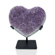 Amethyst crystal heart of lilac druzy points on a black metal post stand, front view on white