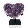 Lavender amethyst crystal heart of even druzy points on a black metal post stand on white