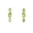 Three faceted green peridot ovals prong set in sterling silver stud earrings