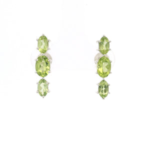 Three faceted green peridot ovals prong set in sterling silver stud earrings