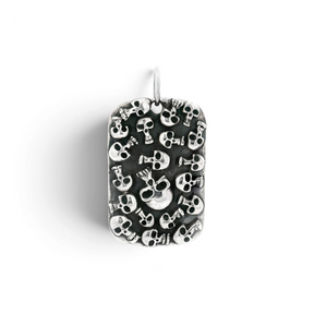 Sterling silver dog tag pendant covered in clustered oxidized skulls