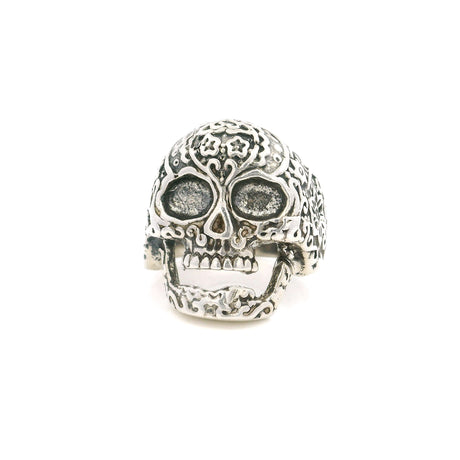 Sterling silver sugar skull ring with floral engraved detail and hollow eye sockets, front view