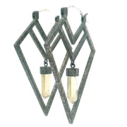 Pale quartz crystal points in oxidized silver diamond arrow hoop earrings, front view on white
