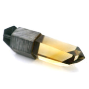 Smoky citrine crystal point pendant with golden tip and oxidized textured sterling silver lantern cap, angled loose view