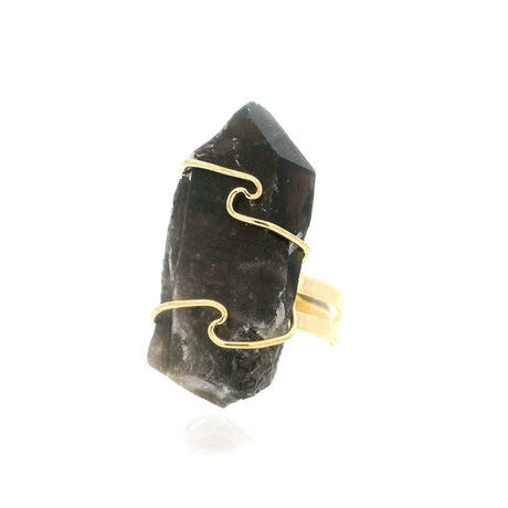 Raw smoky quartz crystal point standing upright in gold wire wrap on brass band