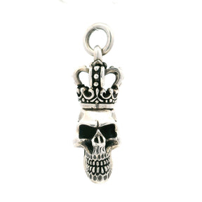 Sterling silver crowned skull pendant with hollow eyes and detailed teeth beneath a royal crown