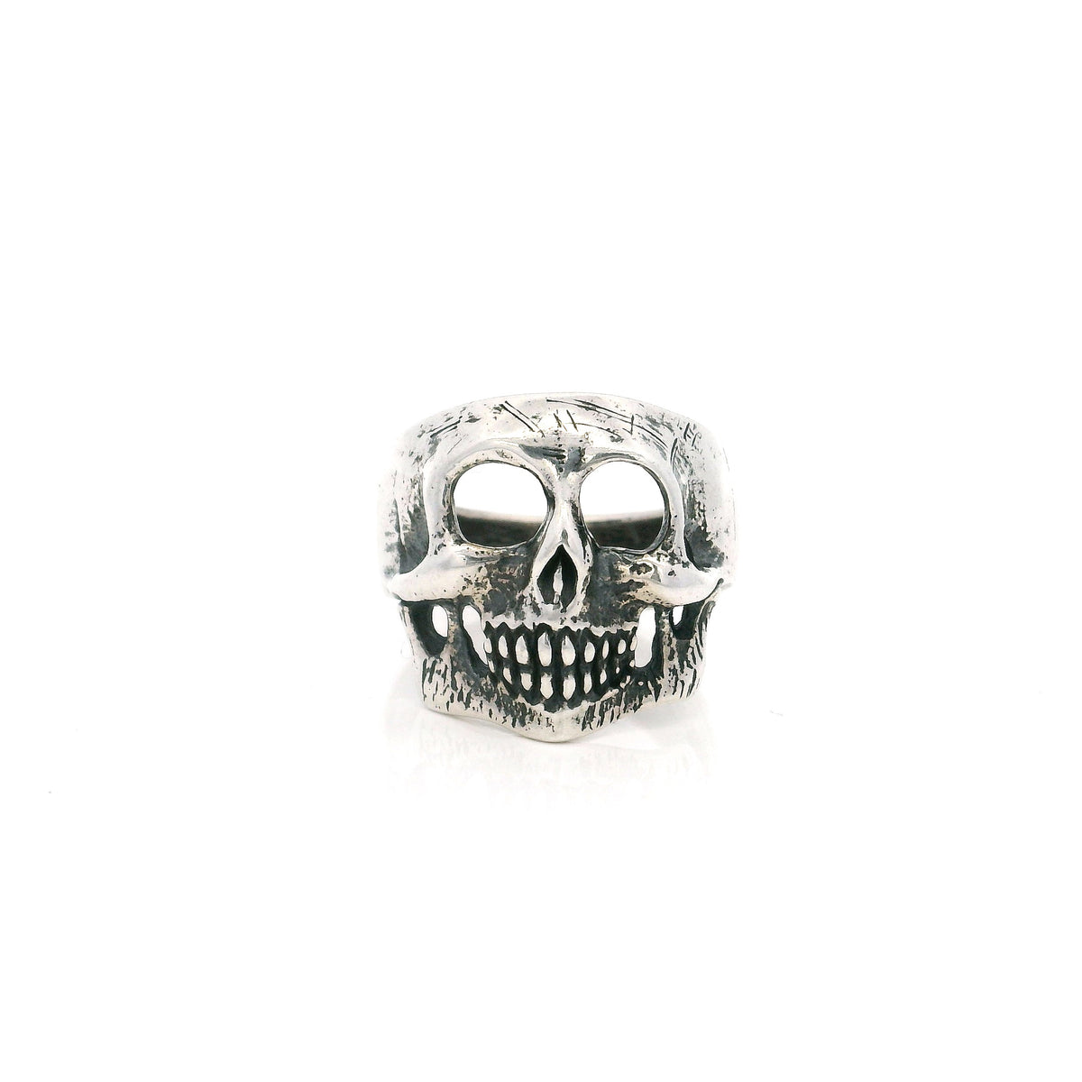 Sterling silver skull ring with hollow eye sockets and grinning teeth in an oxidized finish