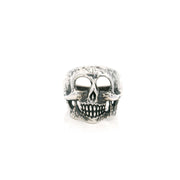 Sterling silver skull ring with hollow eye sockets and grinning teeth in an oxidized finish