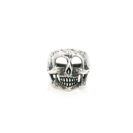 Sterling silver skull ring with hollow eye sockets and grinning teeth in an oxidized finish