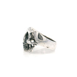 Sterling silver skull ring shown in side profile with a worn oxidized finish