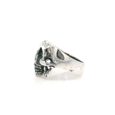 Sterling silver skull ring shown in side profile with a worn oxidized finish