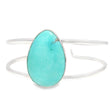 Blue-green turquoise pear cabochon bezel-set on a double-row open-back silver cuff, front view