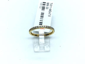 Thin gold-tone titanium band lined with white cubic zirconia pave along the crown