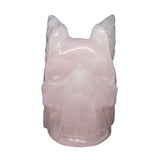 Rose quartz skull with wings carving, front view with wings flared behind
