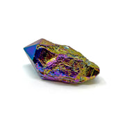 Elongated titanium coated quartz point showing magenta and gold rainbow plating along a terminated tip