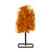 Bright orange citrine crystal plaque with sparkling points mounted on a black metal post stand