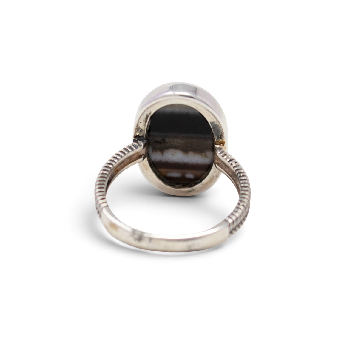 Back of banded agate ring showing open silver bezel and braided sterling band, size 10