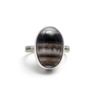 Banded agate ring, oval cabochon with black, brown and white bands in a silver step bezel, front view