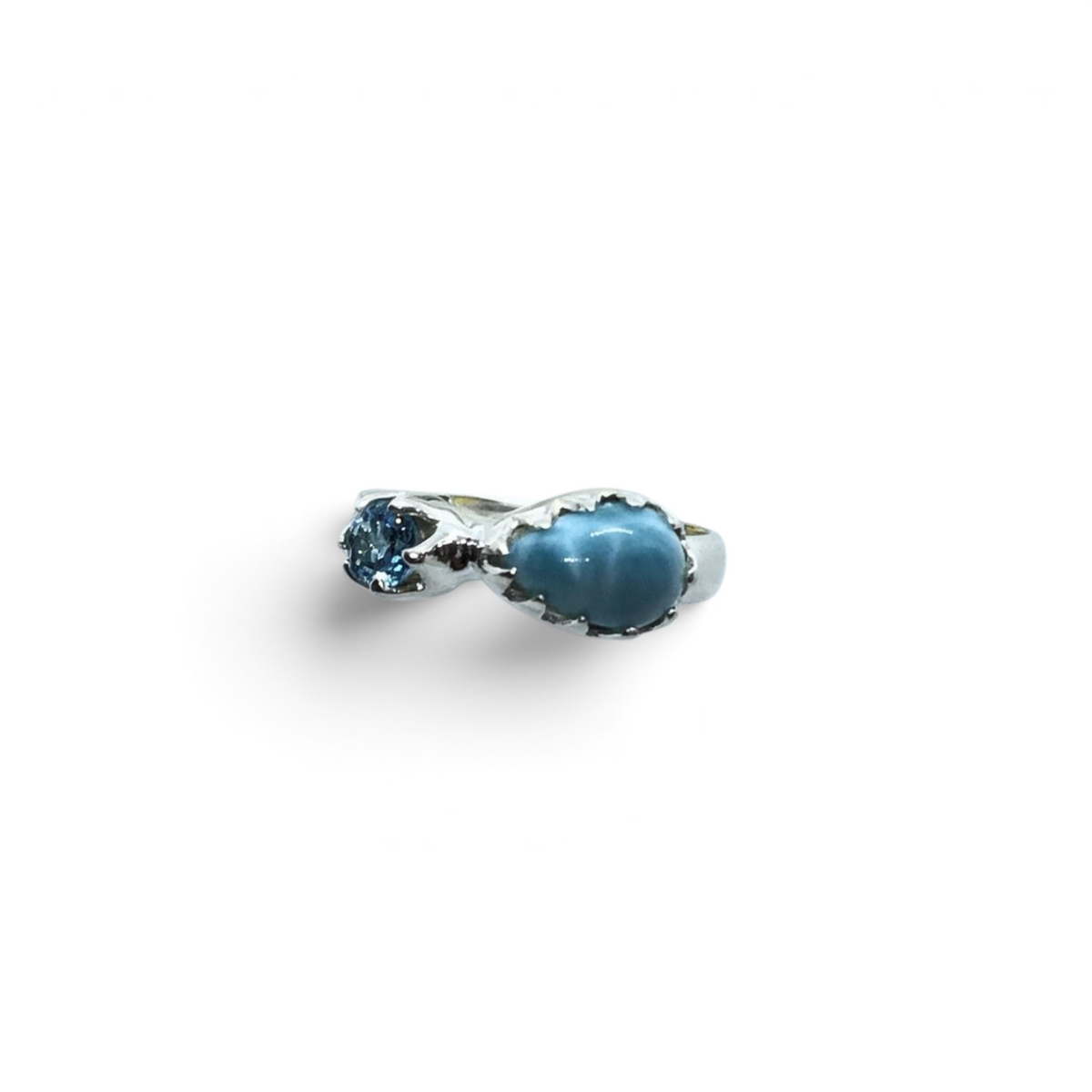 Rare Earth Gallery sterling silver ring featuring an east-west pear larimar cabochon and a faceted blue topaz round.