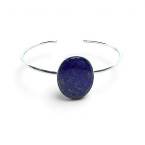 Rare Earth Gallery lapis lazuli cuff bracelet featuring a wide oval cabochon stone in a simple silver bezel setting.