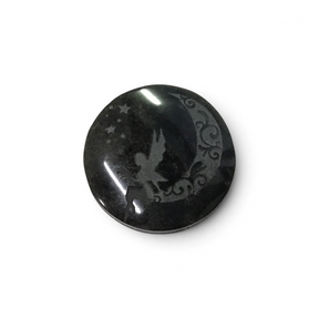 Small round black obsidian cabochon etched with a fairy perched on a scrolled crescent moon and stars