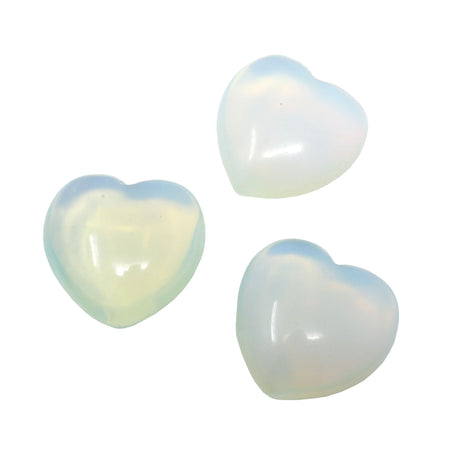 Three translucent milky-white opalite puffy hearts with a soft blue and rainbow glow