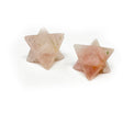 Two carved crystal Merkaba stars in pale pink rose quartz