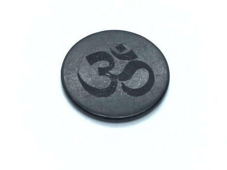 Round shungite cell phone and laptop tile engraved with a dark Om symbol