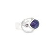 Charoite ring side view showing open silver band and purple cabochon with faceted amethyst accent