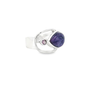 Charoite ring side view showing open silver band and purple cabochon with faceted amethyst accent