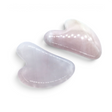 Two pink rose quartz heart-shaped gua sha tools with glossy polished surfaces