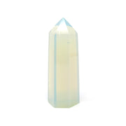 Milky white Opalite tower point with six polished facets and a soft blue glow against a white backdrop