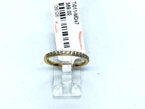 Gold-tone titanium 2mm band ring set with white cubic zirconia halfway around, size 7