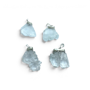 Rare Earth Gallery Faden Quartz pendant collection featuring four unique raw crystal clusters with silver bails.