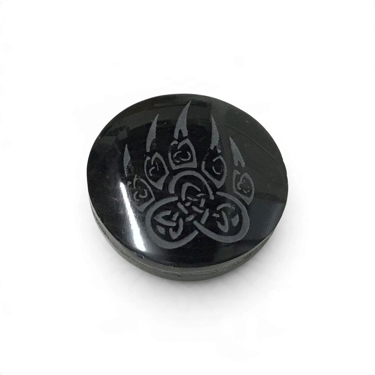 Small glossy black obsidian cabochon etched with a wolf paw print filled with Celtic knotwork symbols
