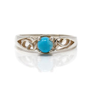 Arizona turquoise ring, round blue cabochon prong-set between silver Celtic knot shoulders