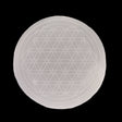 White selenite disc, engraved with Flower of Life sacred geometry, top-down view