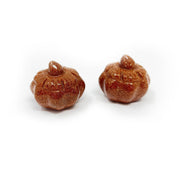 Two carved red goldstone pumpkins with sparkling copper glitter and curled stems