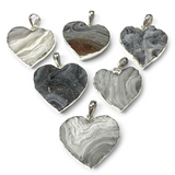 Rare Earth Gallery natural desert druze heart pendants in cool gray tones with polished silver bezels.