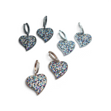 Rare Earth Gallery medium heart-shaped hoop earrings featuring multi-colored nano stones in three metal finishes.