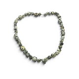 Rare Earth Gallery Dalmatian Jasper necklace featuring smooth, cream-colored tumbled stones with black spotted patterns.