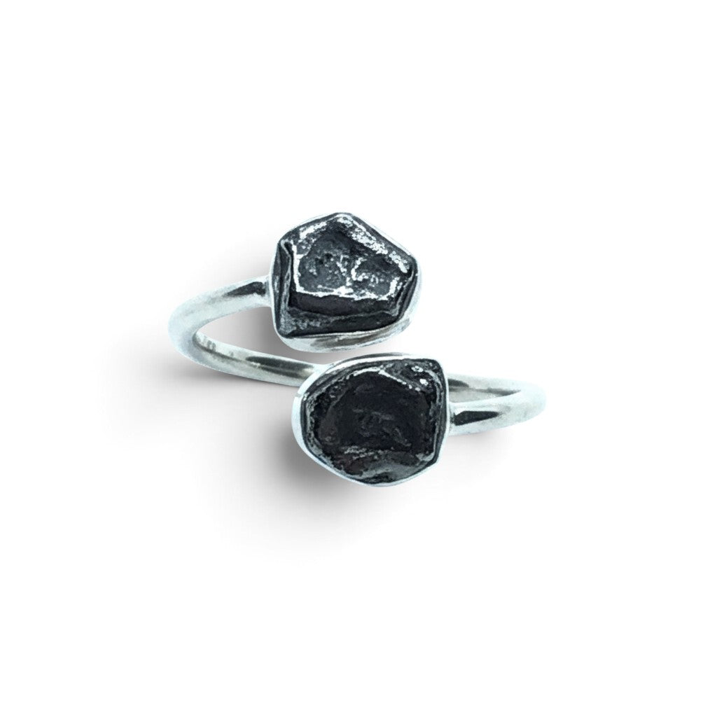Rare Earth Gallery Agoudal meteorite ring with two dark, textured nuggets in a polished silver open band setting.