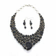 Rare Earth Gallery ammonite fossil necklace set with black spinel and black star garnet. Features spiral ammonites and mixed-cut black gemstones.
