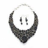 Rare Earth Gallery ammonite fossil necklace set with black spinel and black star garnet. Features spiral ammonites and mixed-cut black gemstones.