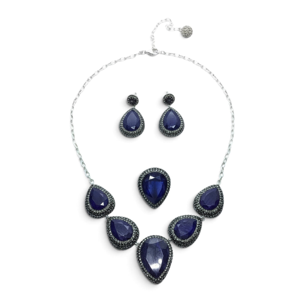 Rare Earth Gallery blue sapphire jewelry set with pear-cut stones, marcasite, and silver crystals on a white background