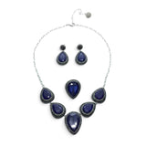 Rare Earth Gallery blue sapphire jewelry set with pear-cut stones, marcasite, and silver crystals on a white background