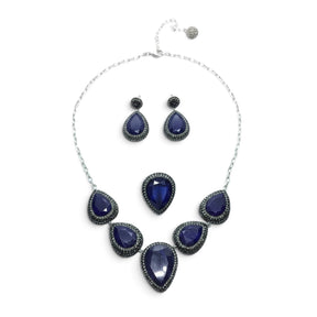Rare Earth Gallery blue sapphire jewelry set with pear-cut stones, marcasite, and silver crystals on a white background