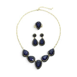 Rare Earth Gallery blue sapphire necklace, pear-shaped earring set, and double band ring with gold overlay and marcasite