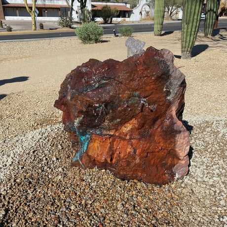 Rare Earth Gallery Arizona copper ore fountain featuring vibrant chrysocolla and specular hematite in a desert garden.